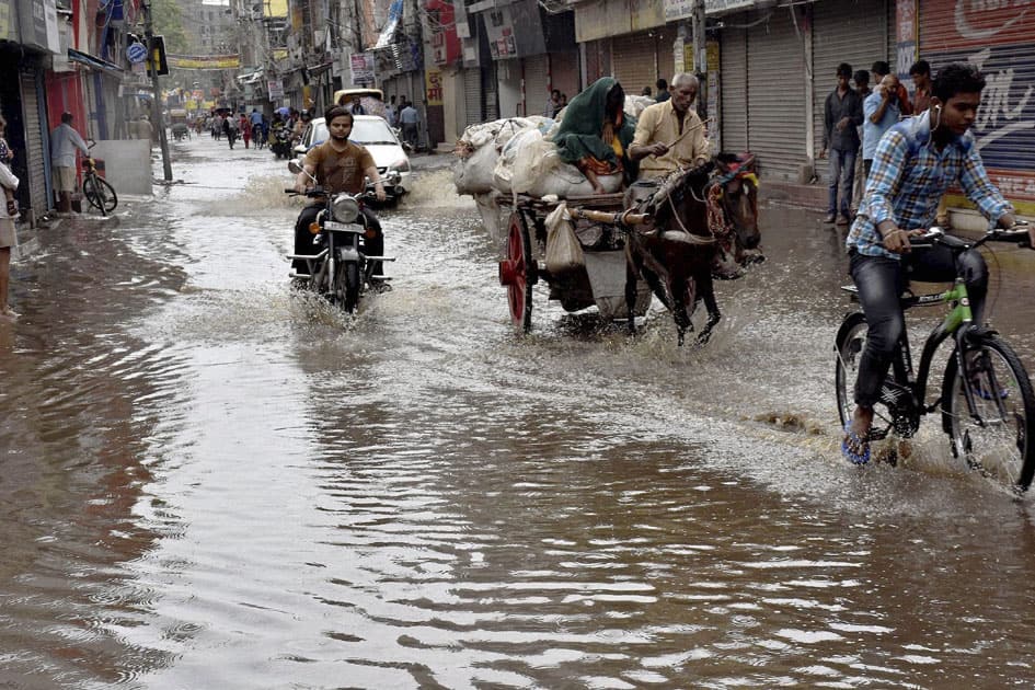 Vehicles move at a waterlogged road after heavy rains in Patna on Saturday.