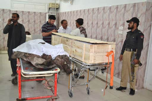 A Pakistani police officer and paramedics stand beside two dead bodies reportedly killed in a U.S. drone strike in the Ahmad Wal area in Baluchistan province, Pakistan, at a hopsital in Quetta, Pakistan.