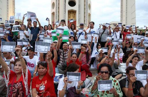 Demonstrators hold up mock voting papers during an anti-coup protest on the steps of Democracy Monument to mark the second anniversary of the military take over of government in Bangkok, Thailand.