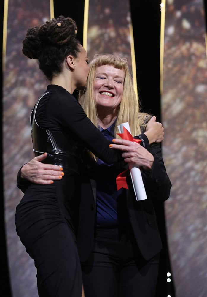 Actress Sasha Lane, left, hugs director Andrea Arnold after she was presented with the Jury Prize for the film American Honey, during the awards ceremony at the 69th international film festival, Cannes.