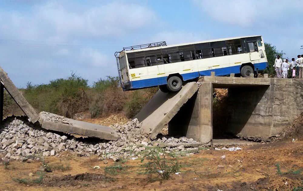 Gujarat state transport corporation bus stuck at a broken bridge which crossing it in Sarod village near Junagadh district Gujarat.