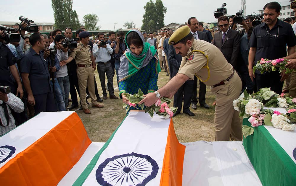 Chief Minister of Jammu and Kashmir, Mehbooba Mufti, lays a wreath on the coffins of three Indian policemen in Srinagar.