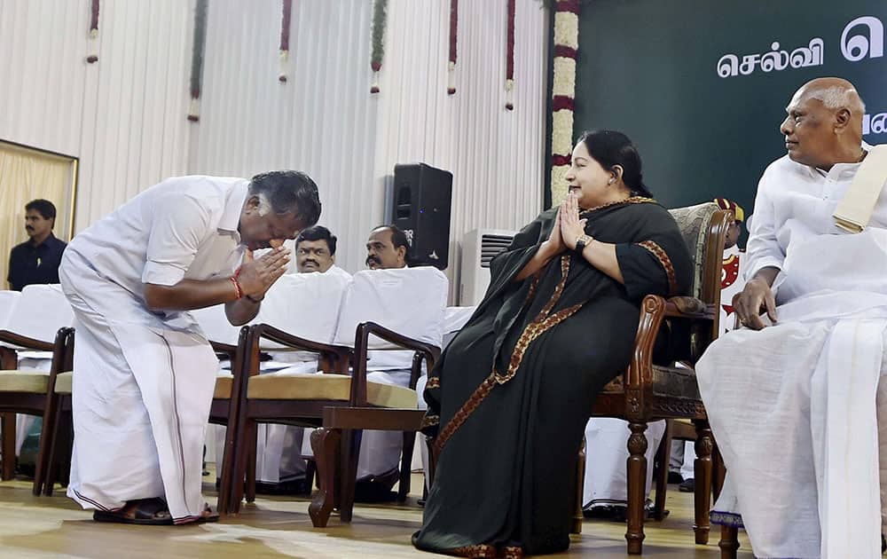 AIADMK leader O Panneerselvam ahead of taking the oath of secrecy as Finance Minister greeting AIADMK supremo J Jayalalithaa at the swearing in ceremony at Madras University Centenary Auditorium in Chennai.