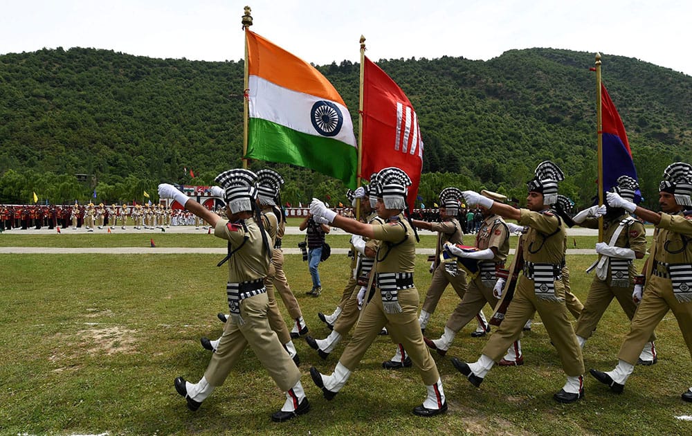 Jammu and Kashmir Armed Police carry National flag during passing out parade at the Sheeri Training Centre in Baramulla District.