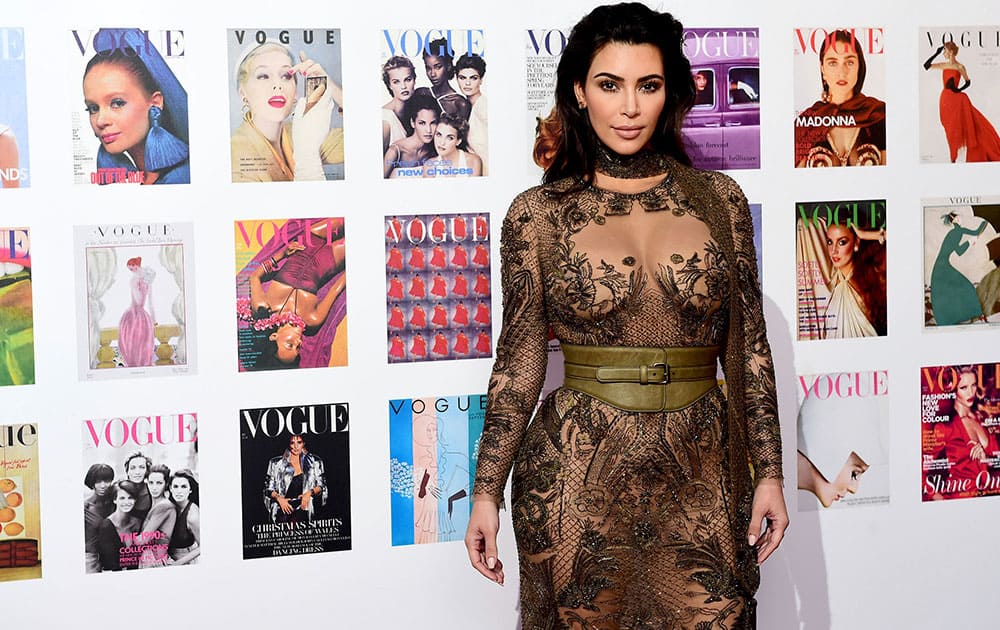 Kim Kardashian poses for photographers as she arrives for The Vogue 100 Gala Dinner at East Albert Lawn, in London.