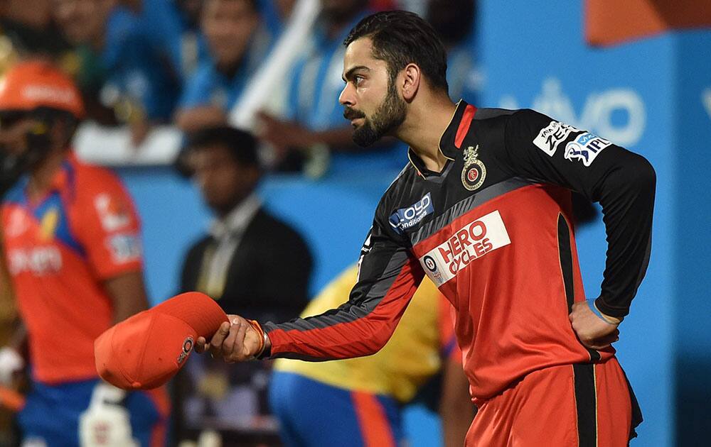 Royal Challengers Bangalores Virat Kohli celebrates after taking the catch of Eklavya Dwivedi during the 1st qualifier IPL 2016 match against Guajrat Lions at Chinnaswamy Stadium in Bengaluru.
