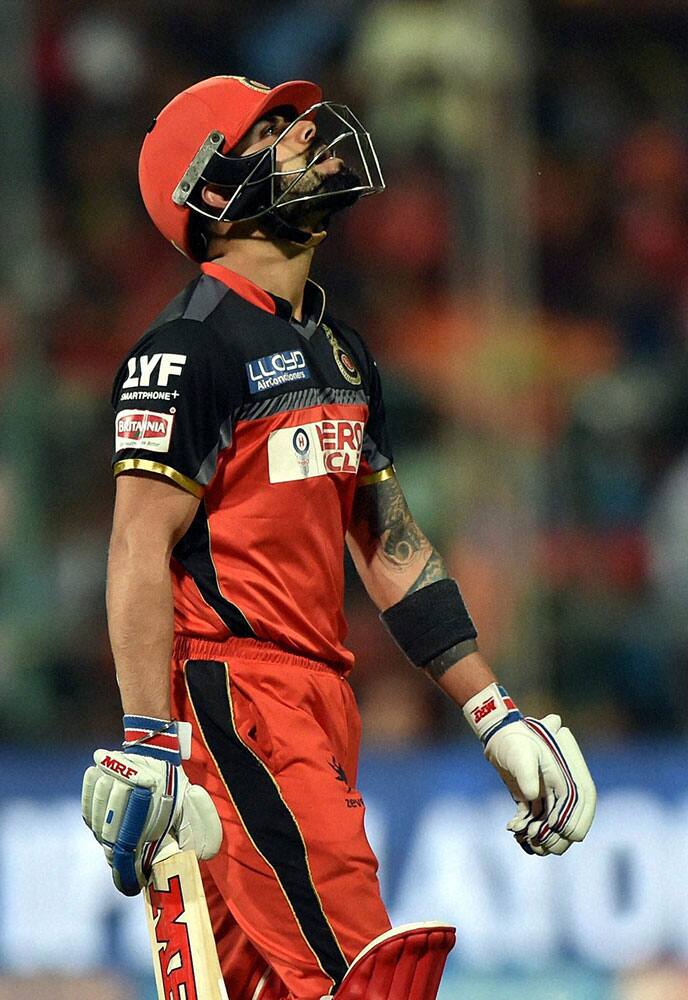 Royal Challengers Bangalores Virat Kohli returns the pavilion after his dismmisal during the 1st qualifier IPL 2016 match against Guajrat Lions at Chinnaswamy Stadium in Bengaluru.