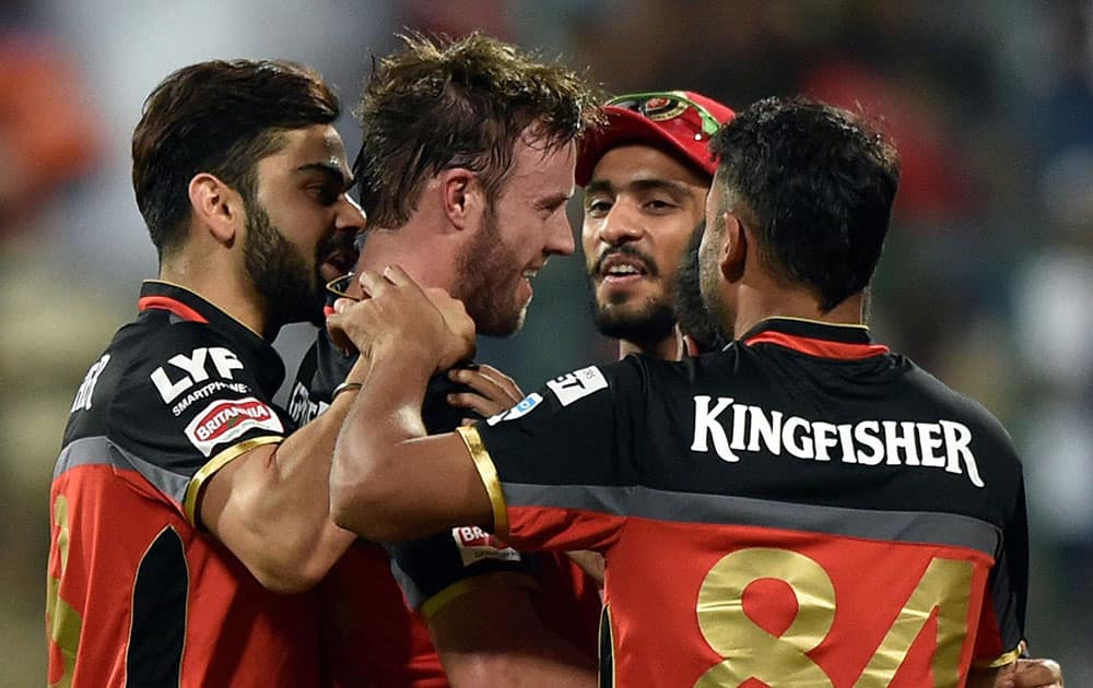 Royal Challengers Bangalores AB De Villiers with team mates celebrate after winning during the 1st qualifier IPL 2016 match against Gujarat Lions at Chinnaswamy Stadium in Bengaluru.