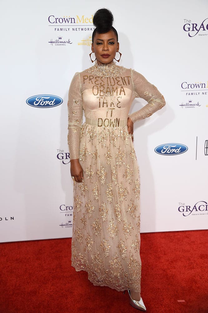 Aunjanue Ellis arrives at the 41st annual Gracie Awards Gala wearing a gown with the message, 