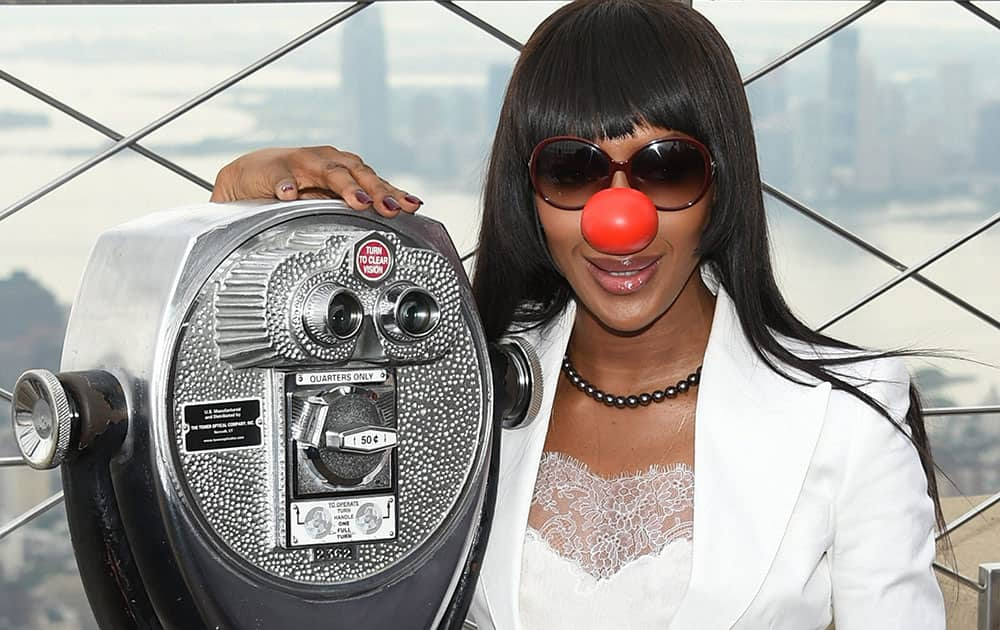 Model Naomi Campbell poses on the observatory of the Empire State Building in honor of Red Nose Day in New York. 
