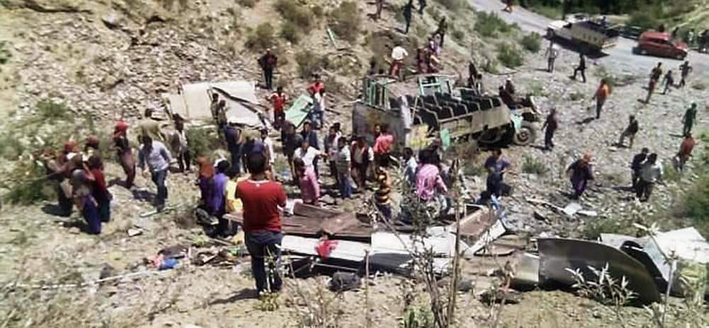 Villagers carry out rescue work at the accident site in Chauri Ghatti where a passenger bus rolled down, near Bhaitronjkhan in Salt Tehsil, Almora.
