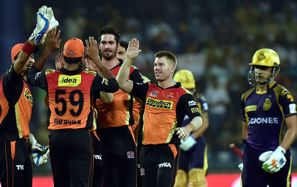 Sunrisers Hyderabad bowler Ben Cutting with team mates celebrate the wicket of KKRs batsman Gautam Gambhir during the IPLT20 eliminator match at Feroz Shah Kotla in New Delhi.