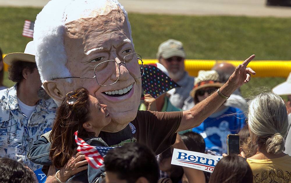 A supporter kisses a puppet of Democratic presidential candidate Sen. Bernie Sanders, I-Vt., during a campaign rally in Cathedral City, Calif.