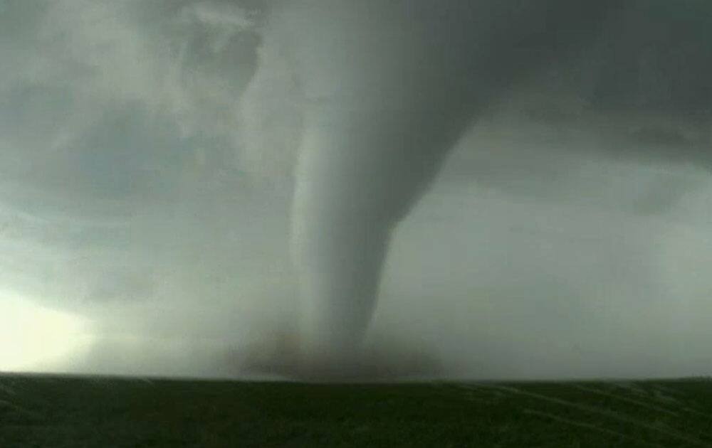 This image made from a video by KWTV-KOTV, shows a funnel cloud moving across the field near Dodge City in Ford County, Kan. 