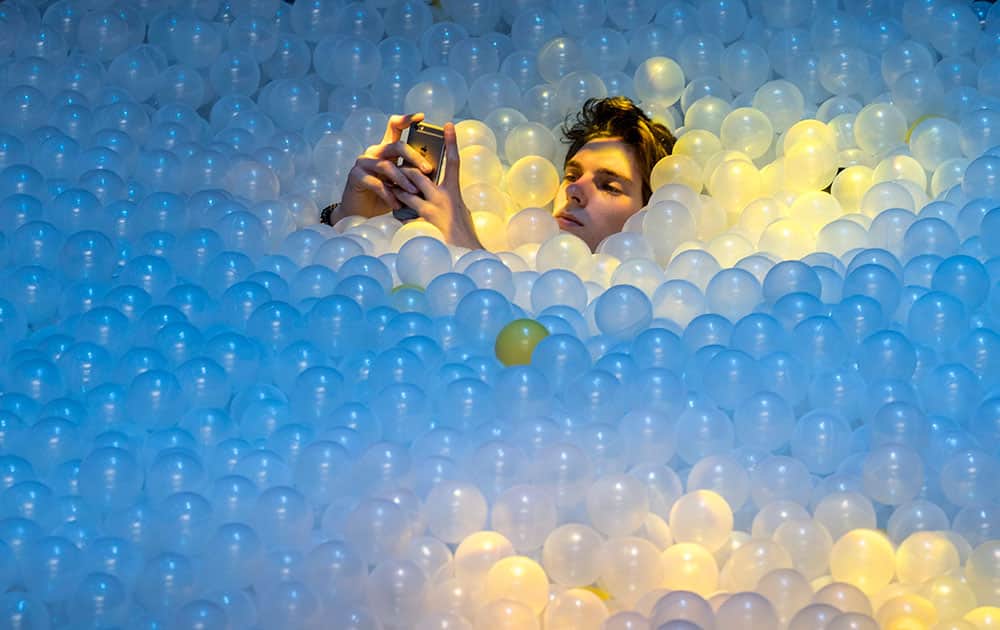 A participant takes a break in a plastic ball swimming pool at the C2MTL business conference, in Montreal. 