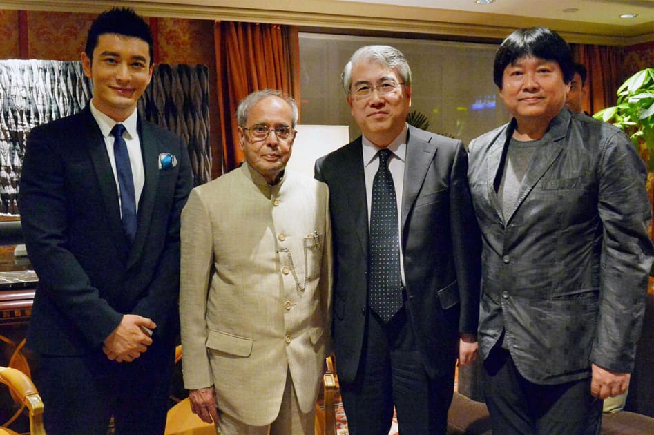 President Pranab Mukherjee with famous Chinese film actor, Huang Xiaoming (L) and others in Beijing, China.
