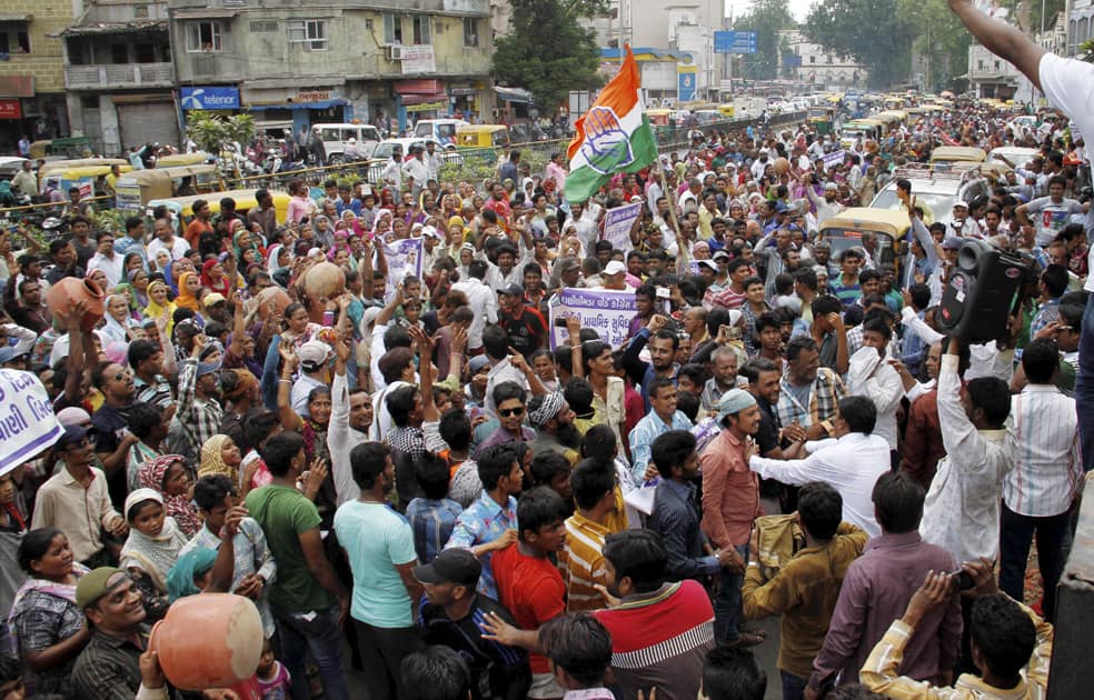 People carry earthen pitchers and shout anti BJP slogans during a protest against shortage of drinking water in Ahmedabad.