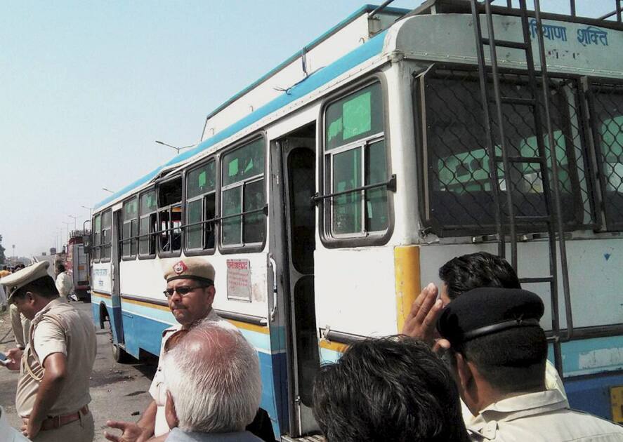 Police guarding a bus in which a bomb exploded at Pipli in Kurukshetra.