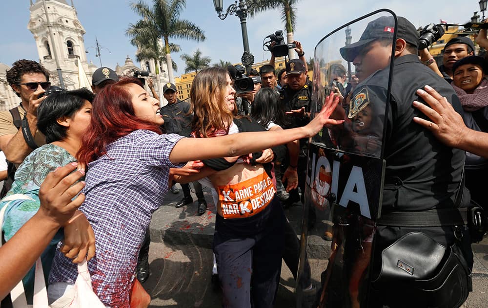 Police try to break up a protest against presidential candidate Keiko Fujimori outside the presidential palace in Lima, Peru.