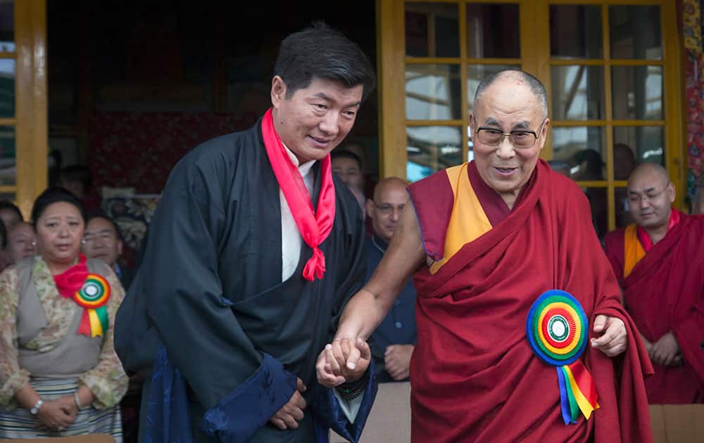 Tibetan spiritual leader the Dalai Lama, right, smiles as he poses for a photograph with Lobsang Sangay, who was sworn in as Prime Minister of the Tibetan government-in-exile for the second five-year term in Dharmsala.