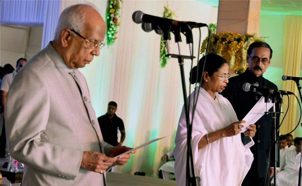 West Bengal Governor Keshari Nath Tripathy administers the oath of secrecy to West Bengal Chief Minister Mamata Banerjee during swearing-in ceremony in Kolkata.