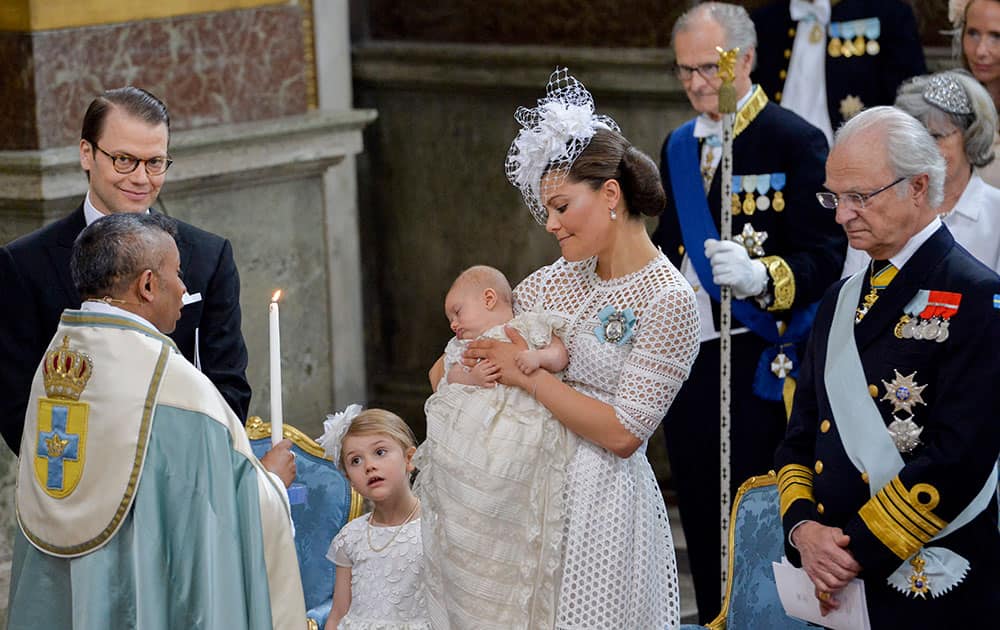Sweden's Crown Princess Victoria holds Prince Oscar while Princess Estelle looks on at Prince Oscar's christening in the Chapel at the Royal Palace in Stockholm.