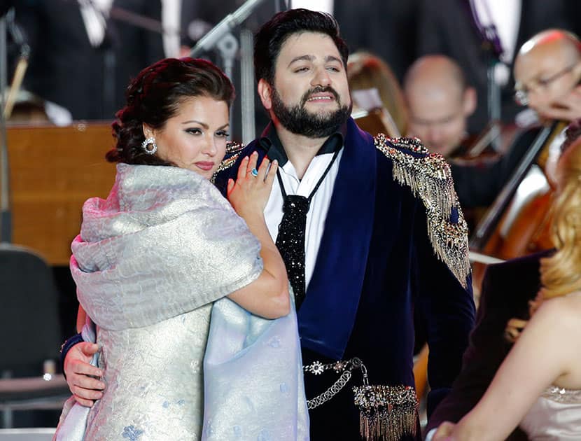 Soprano Anna Netrebko, left, and tenor Yusif Eyvazov perform during an opera concert marking St.Petersburg's 313th anniversary at Dvortsovaya (Palace) Square in St.Petersburg, Russia.