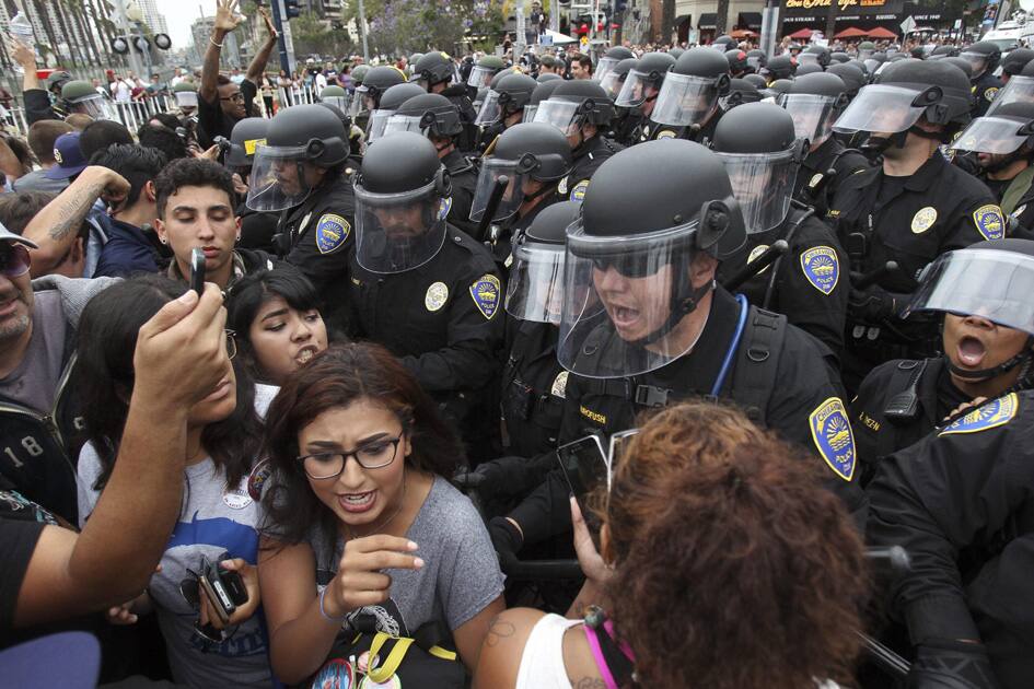 Police move anti-Trump protesters back toward Harbor Drive as they try to disperse crowds of protesters and Trump supporters that were clashing near the San Diego Convention Center where Republican presidential candidate Donald Trump held a campaign rally.