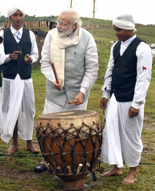 Prime Minister Narendra Modi tries his hands at a drum in Heritage Mawphlang village of Meghalaya.