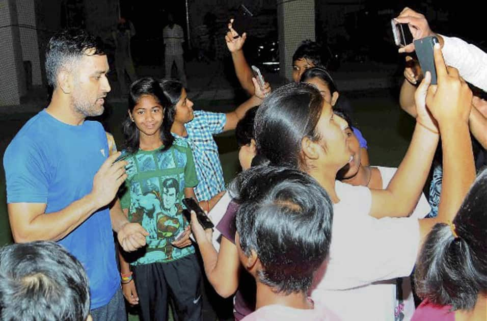 Indian cricket team skipper Mahendra Singh Dhoni poses for fans at Jharkhand state cricket association International Cricket stadium in Ranch.