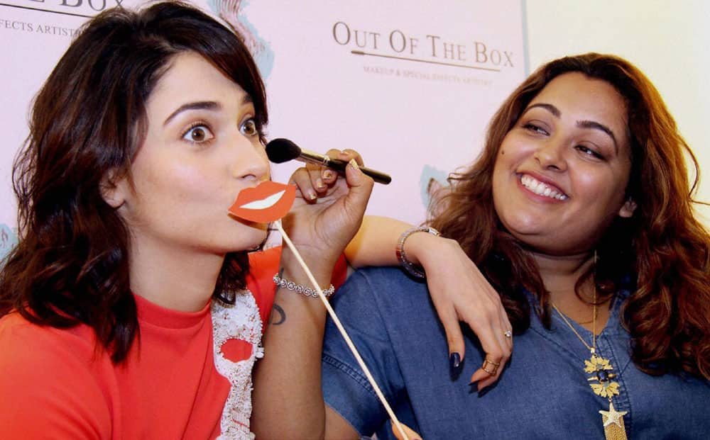 Bollywood actor Tamannah Bhatia during the launch of makeup academy of Billy Manik (R) in Mumbai.