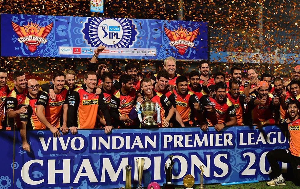 Sunrisers Hyderabad players celebrate with the winning trophy of IPL 2016 after beating Royal Challengers Bangalore in the final match at Chinnaswamy Stadium in Bengaluru.