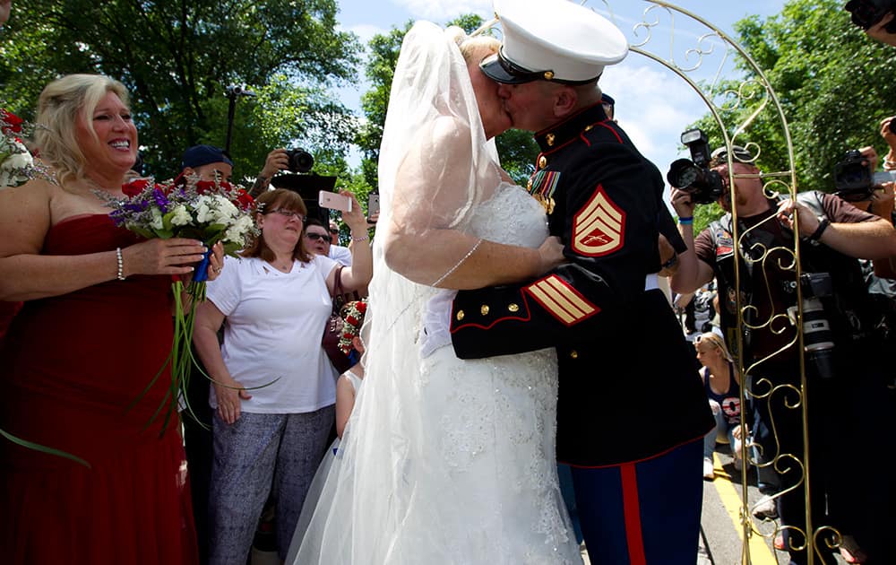 Marine Tim Chambers kisses his wife, Lorraine Heist, after their wedding ceremony, before the annual Rolling Thunder parade in Washington.