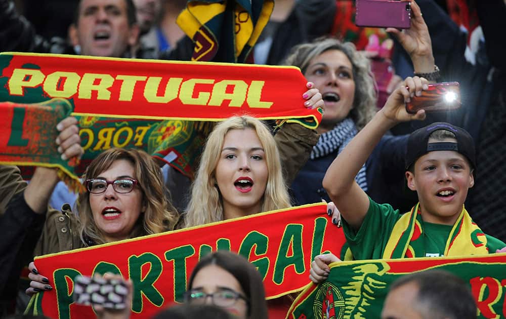 Portugal's fans react on the stands prior to a friendly soccer match between Portugal and Norway at the Dragao stadium in Porto, Portugal. Two second-half goals in seven minutes from Raphael Guerreiro and Eder helped Portugal to a 3-0 win over Norway in a warmup game Sunday for the European Championship.