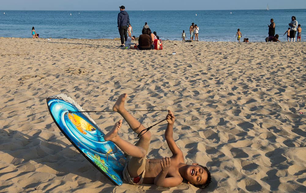 Gabriel Cordromp, 8, plays on the beach after beach goers were told over the loud speaker to get out of the water at Corona del Mar beach in Newport Beach, Calif.