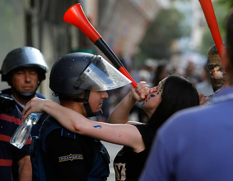 People attend an anti-government protest marching through a street in Skopje, Macedonia.