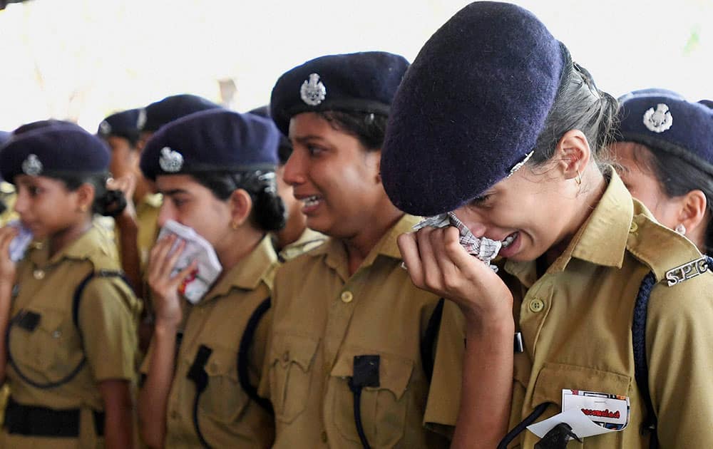 Student cadets mourn near the bodies (unseen) of five children who drowned in river at Tirur, Payyavoor, in Kannur.