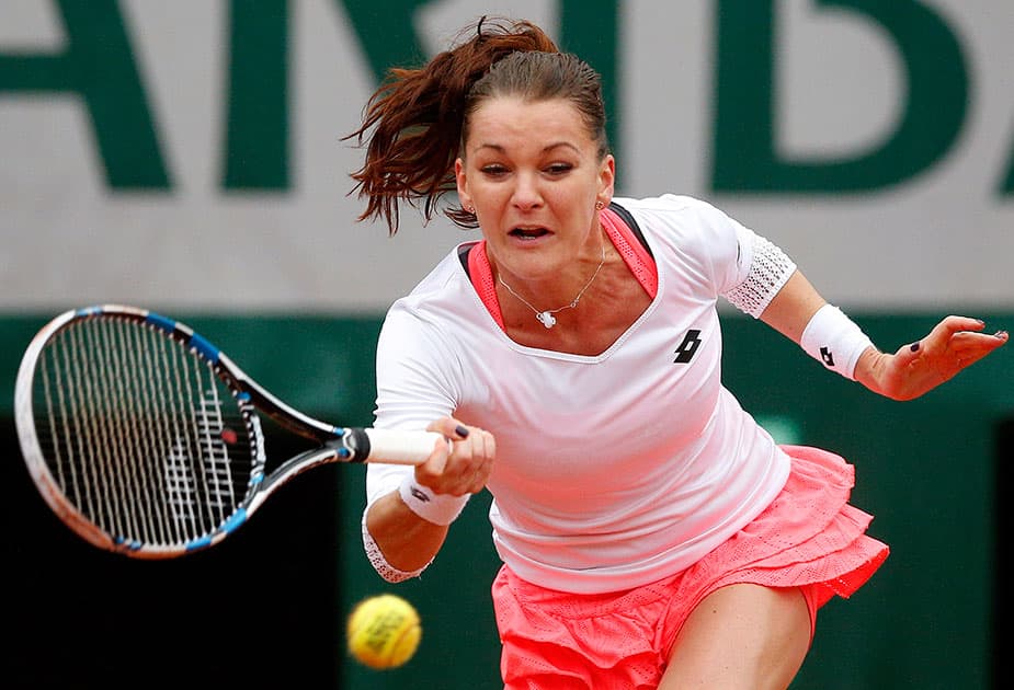 Poland's Agnieszka Radwanska returns the ball to Bulgaria’s Tsvetana Pironkova during their fourth round match of the French Open tennis tournament at the Roland Garros stadium, in Paris.