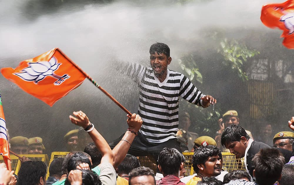 Police spray water cannons to disperse BJP members during their protest against Delhi Chief Minister Arvind Kejriwal outside his residence in New Delhi on Tuesday against sporadic power cuts and poor water supply in the capital.