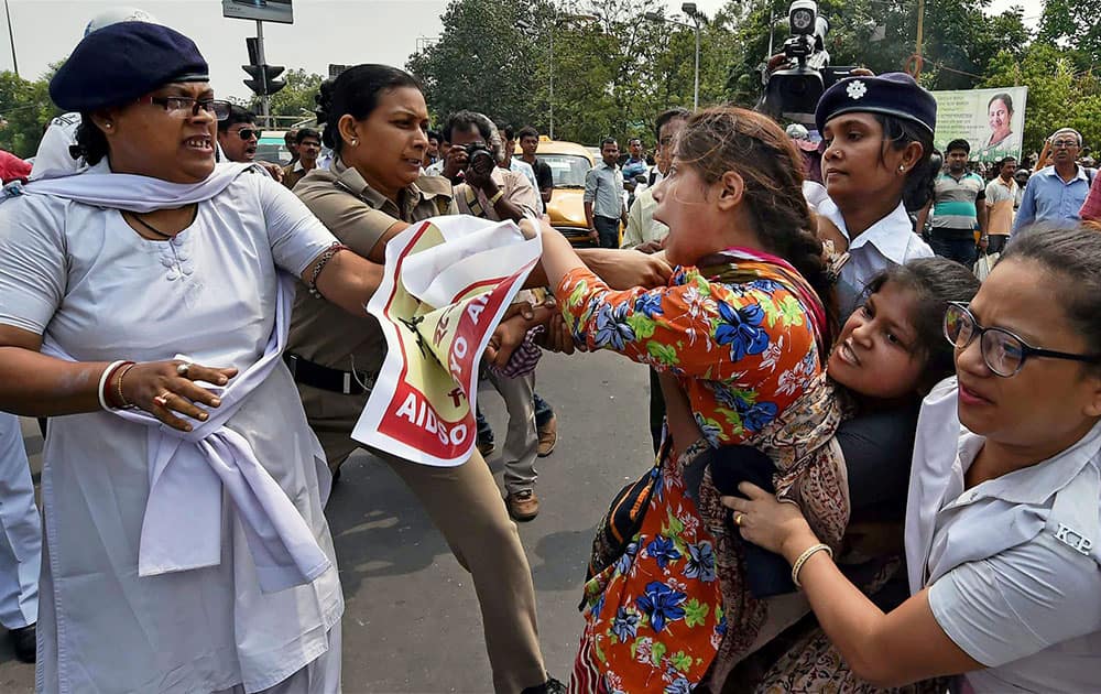Police detain the AIDSO activists who were holding a protest against the gang rape of a woman, in Kolkata.