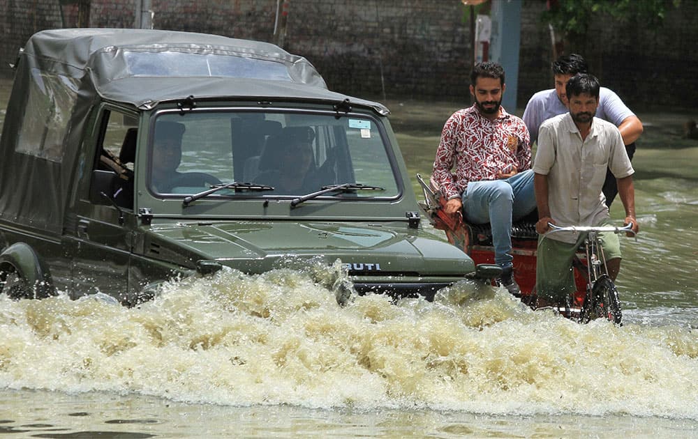 An army vehicle crossing an inundated road in Civil Lines area in Bathinda after heavy rains.
