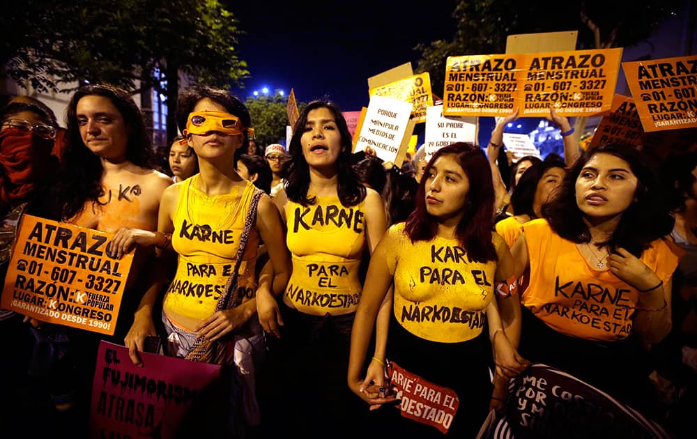 Demonstrators representing female victims of forced sterilization during Alberto Fujimori's government, protest against his daughter, presidential candidate Keiko Fujimori, in downtown Lima, Peru.