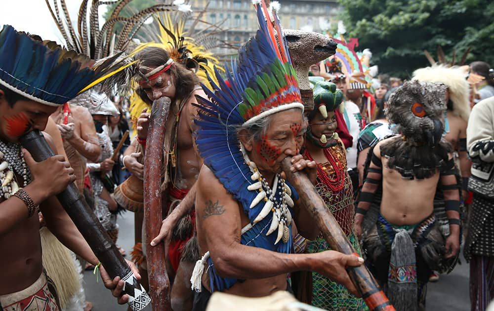 People belonging to indigenous tribes dance in front of the Sforza Castle, during 'Lo spirito del Pianeta' (The Spirit of the Planet) International Festival of Indigenous Peoples, in Milan, Italy.