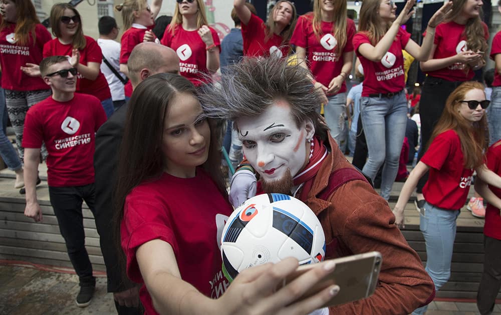 Russian volunteers make a selfie before a launching ceremony, in Moscow, Russia.