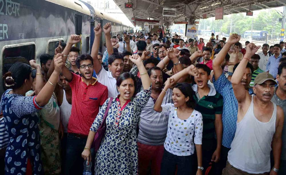 Angry passengers shout slogans against dysfunctioning of air conditioners inside the West Bengals Sampark Kranti Express train at Allahabad Railway station.