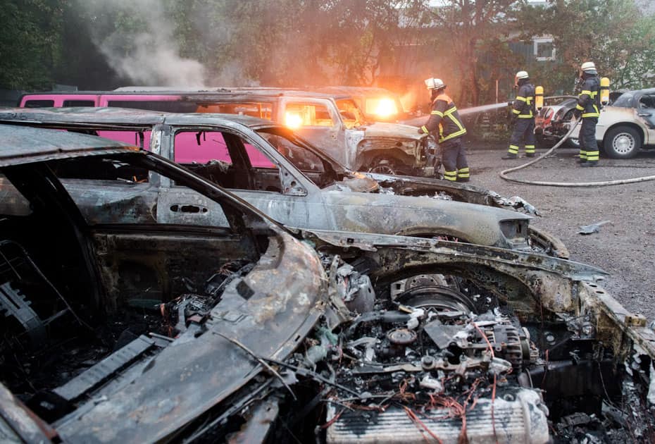 Firefighters extinguish burning cars in Hamburg, Germany.