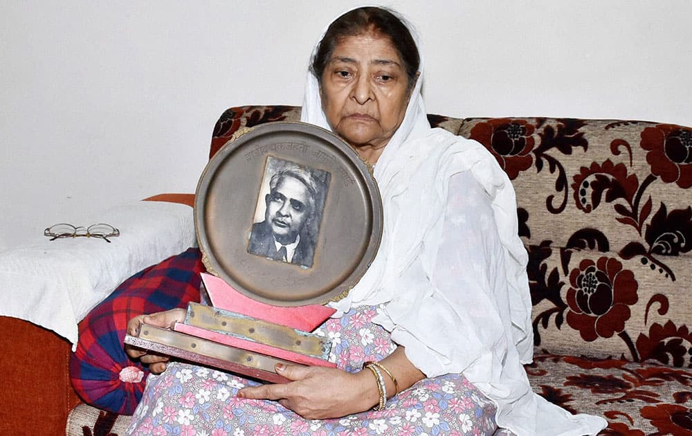 Zakia Jafri, the wife of slain Congress MP Ehsan Jafri showing her husbands photo while reacting on the verdict in Gurbarg Society massacre case, in Surat.