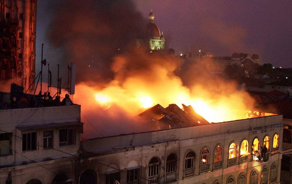 Fire personnel dousing a major fire that broke out at a building in the Colaba Causeway in South Mumbai.
