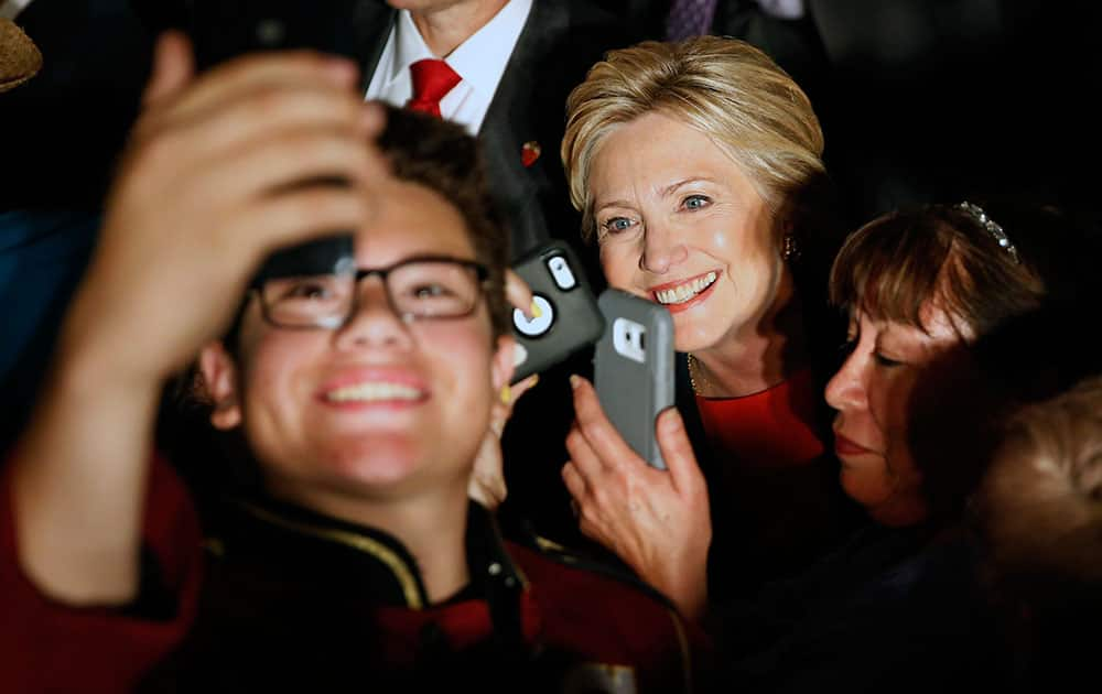 Democratic presidential candidate Hillary Clinton poses for photos at a rally, in El Centro, Calif. 