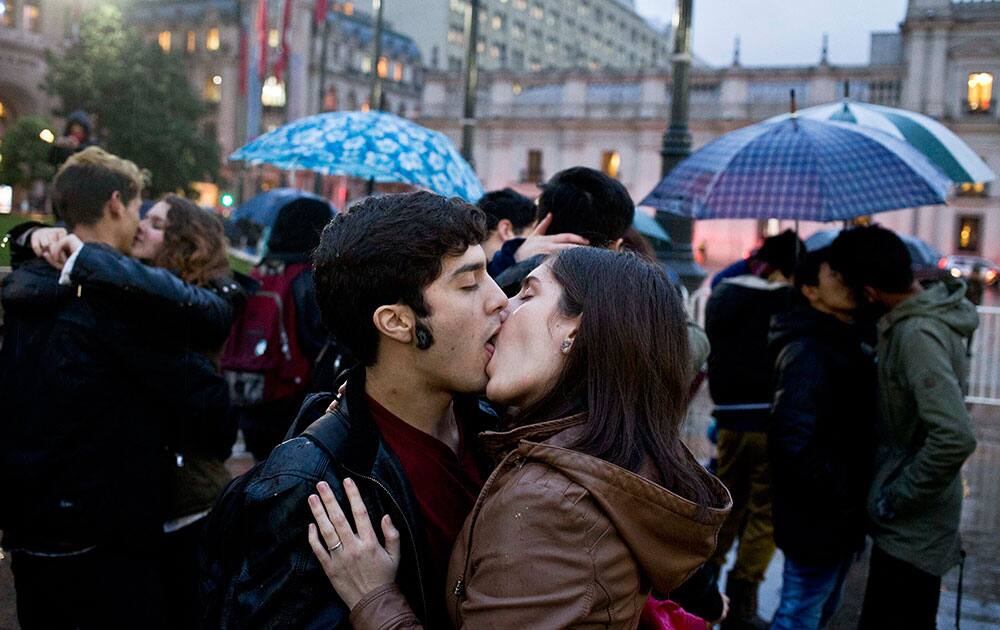 Couples kiss during a demonstration to demand educational reforms, in front of La Moneda Palace in Santiago, Chile.